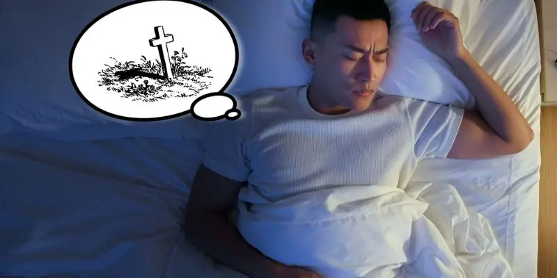 a man sleeping in bed with a cross